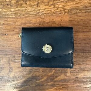 Black leather wallet with a red interior.